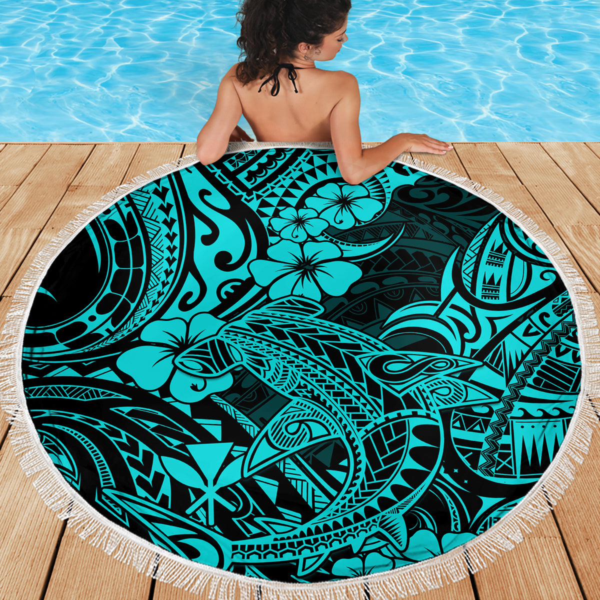 Circular turquoise beach blanket featuring shark tribal pattern, white fringed edge