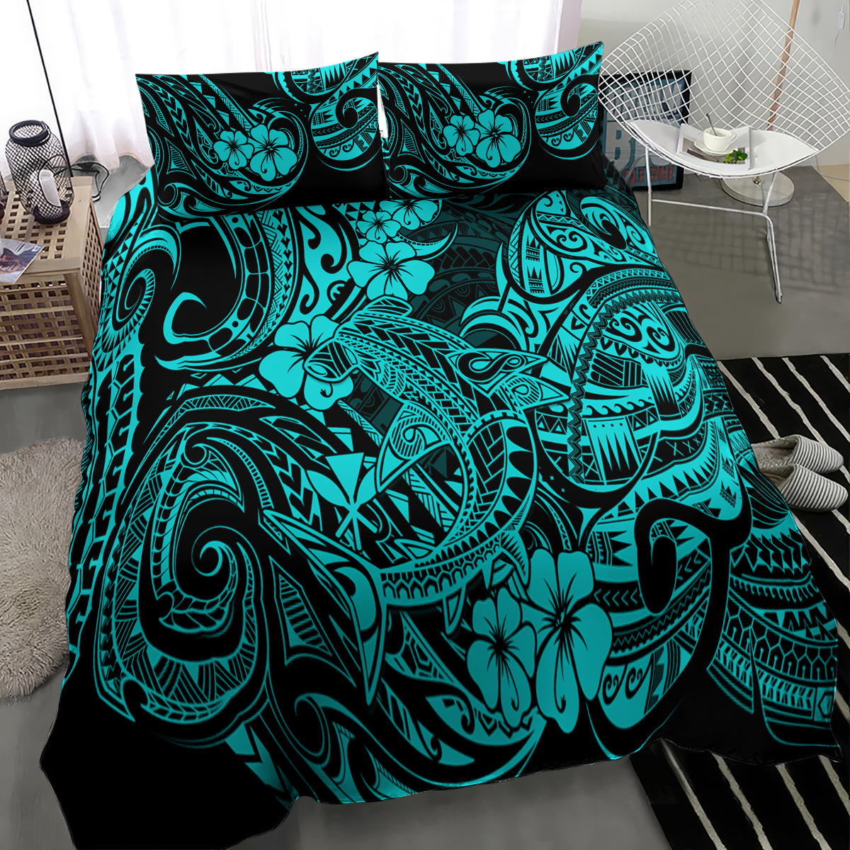 Turquoise Polynesian print comforter and pillowcases on a bed, close-up view
