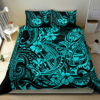 Turquoise Polynesian print bedding set on a bed with two matching pillowcases