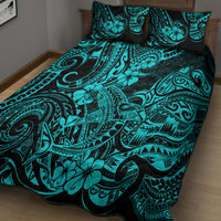 Turquoise quilt bed set with tribal swirl and floral motifs, shown on bed with pillows