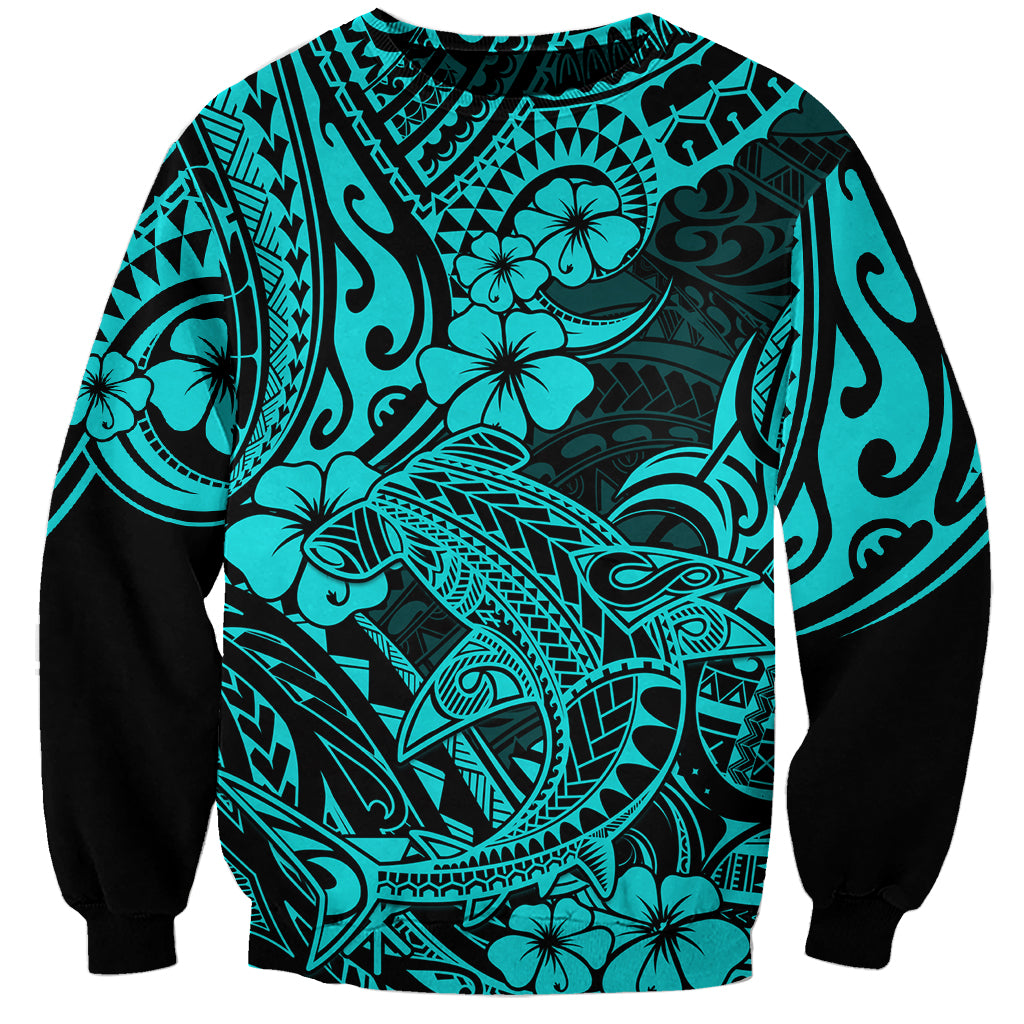 Unisex turquoise sweatshirt with black sleeves and bold Polynesian shark graphic