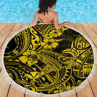 Round Polynesian print beach blanket in yellow and black with a white fringed border.