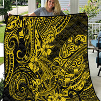 Yellow and black Polynesian shark pattern quilt, folded with quilted edges visible