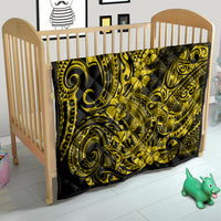 Yellow and black Polynesian shark quilt in wooden baby crib