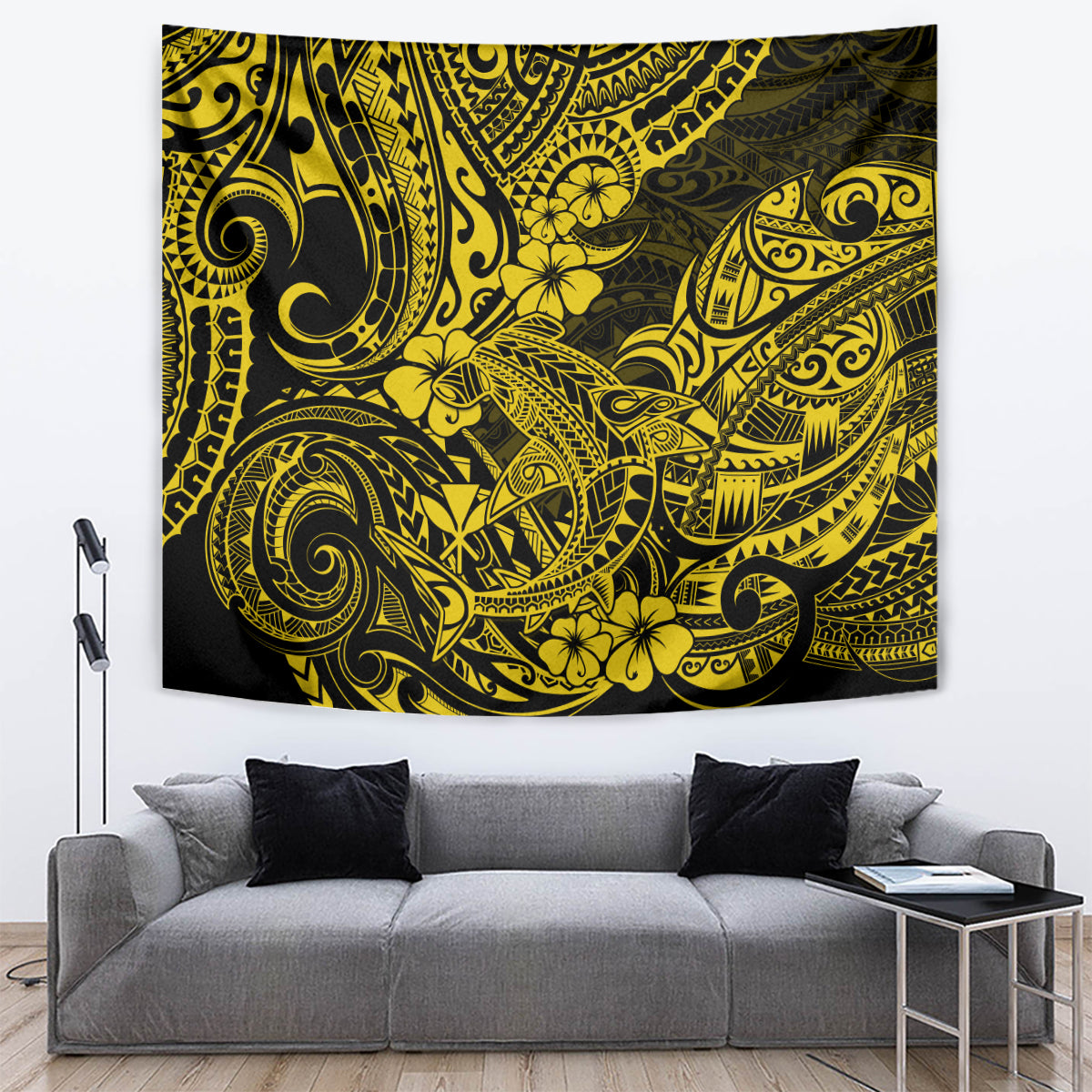 Yellow and dark Polynesian pattern tapestry on wall above gray couch