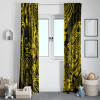 Yellow and black Polynesian patterned curtains hanging across a wide window