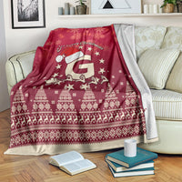 Red Christmas blanket over bed with Santa riding reindeer, snowflakes, stars, and border