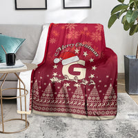 Red Christmas blanket on chair with Santa riding reindeer, snowflakes, stars, and trees