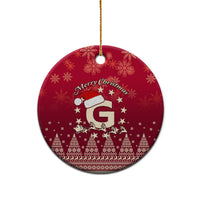 Red ceramic round Christmas ornament with Santa riding reindeer and letter G, gold hanging loop