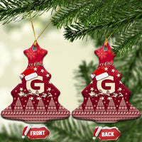 Red ceramic bell-shaped Christmas ornament with Santa riding reindeer and letter G, gold hanging string