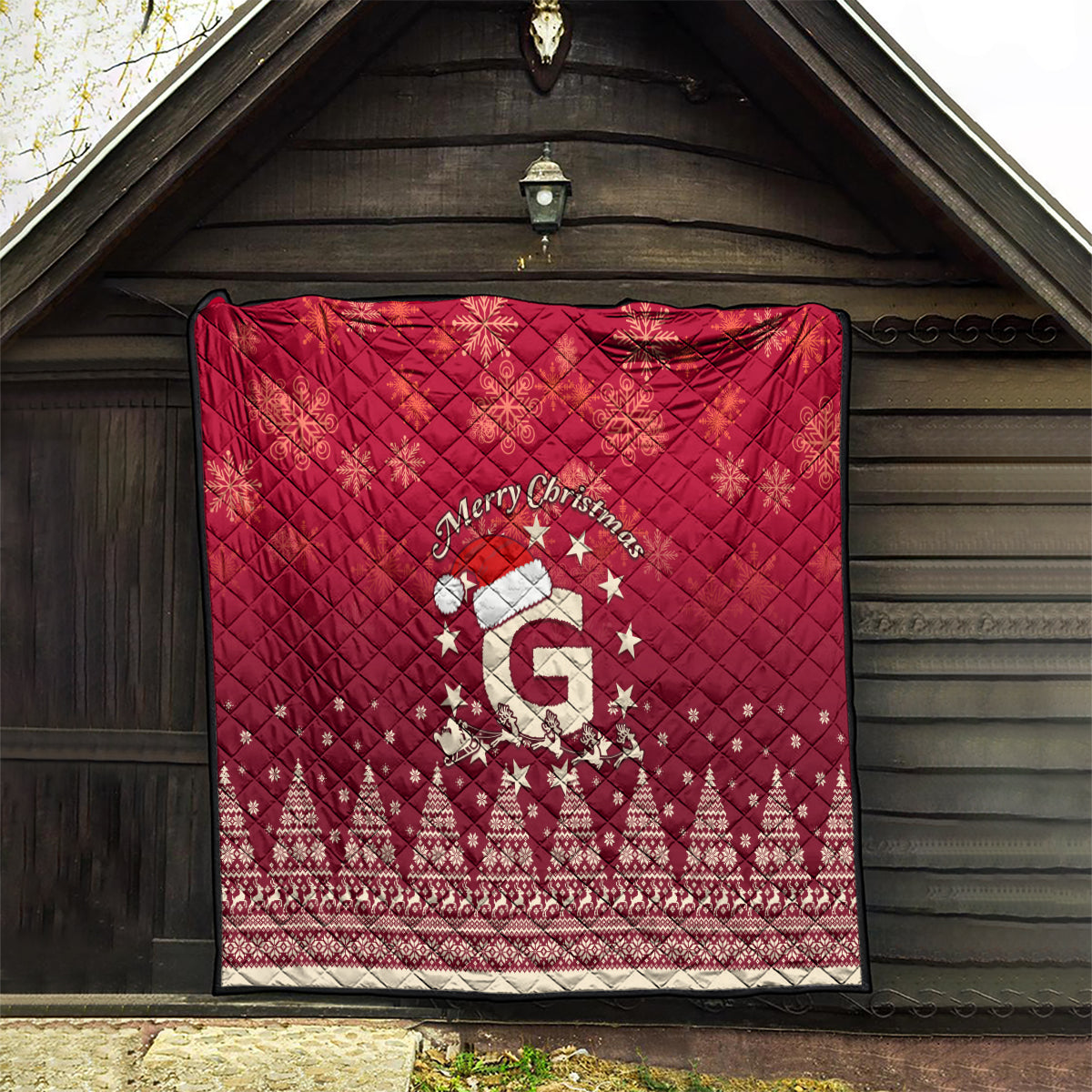 Red quilt blanket with quilted texture and “Merry Christmas” Santa riding reindeer scene