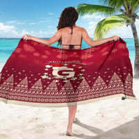 Red Christmas sarong with "Merry Christmas" text and Santa graphic, worn as wrap