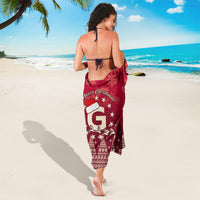 Red Christmas sarong wrap with Santa and star accents, tied at the waist