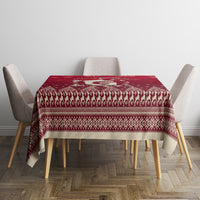 Red Christmas tablecloth with festive border and patterned center panel on dining table