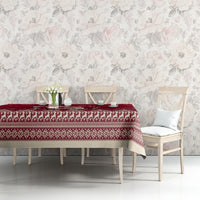 Red Christmas tablecloth with decorative border and small snowflake pattern on table