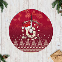 Red Christmas tree skirt with Santa and reindeer print, white fringe edge