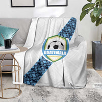 White Guatemala football blanket over chair with blue geometric stripe and crest
