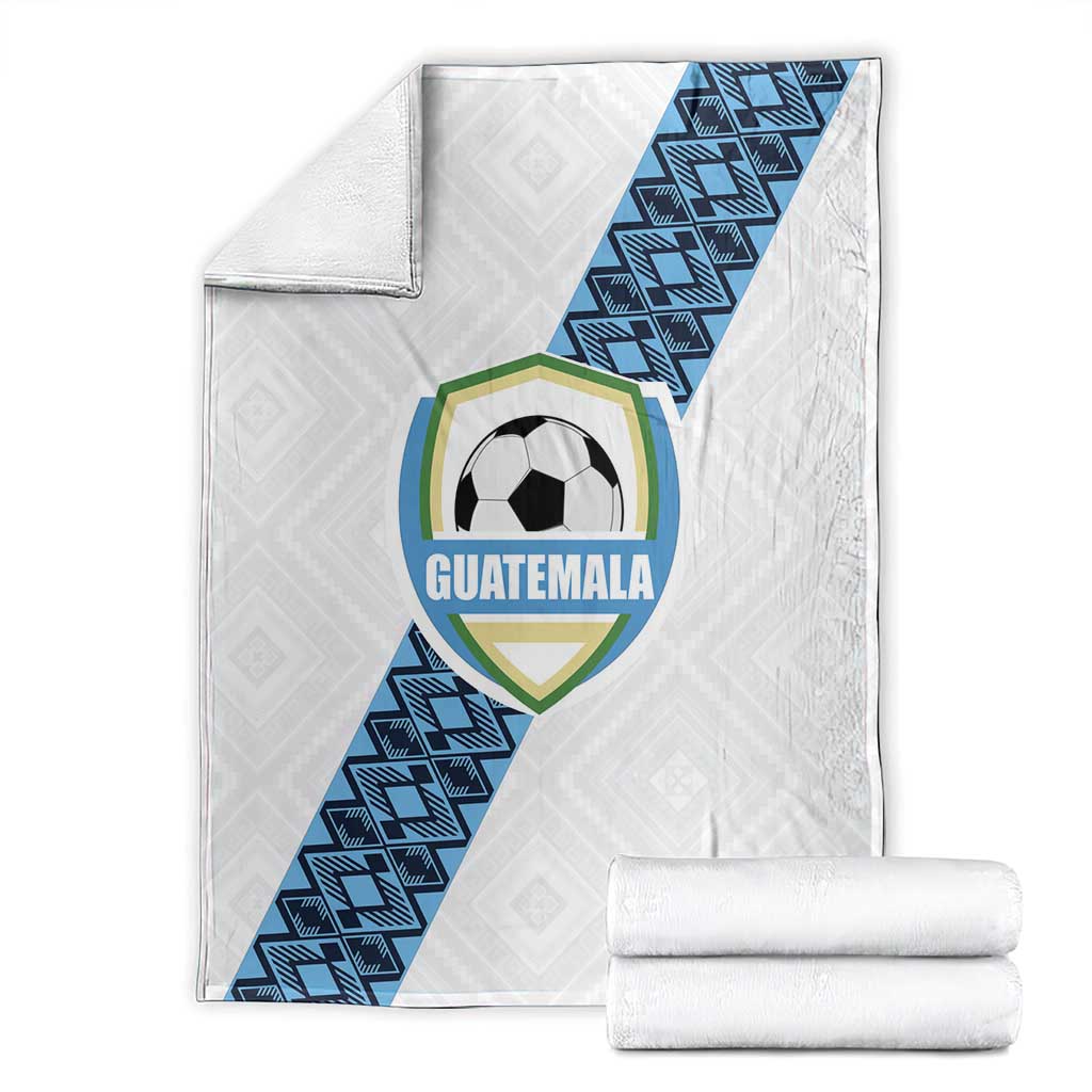 White Guatemala football blanket with blue diagonal stripe crest, folded and rolled