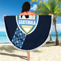 Round navy beach blanket with white fringe and Guatemala crest soccer-ball graphic, held outdoors