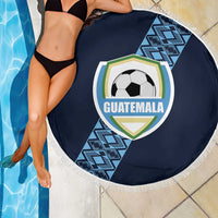 Round navy beach blanket with white fringe and Guatemala crest soccer-ball graphic by poolside
