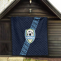 Navy football quilt hanging on door, diamond quilting with diagonal stripe and Guatemala crest