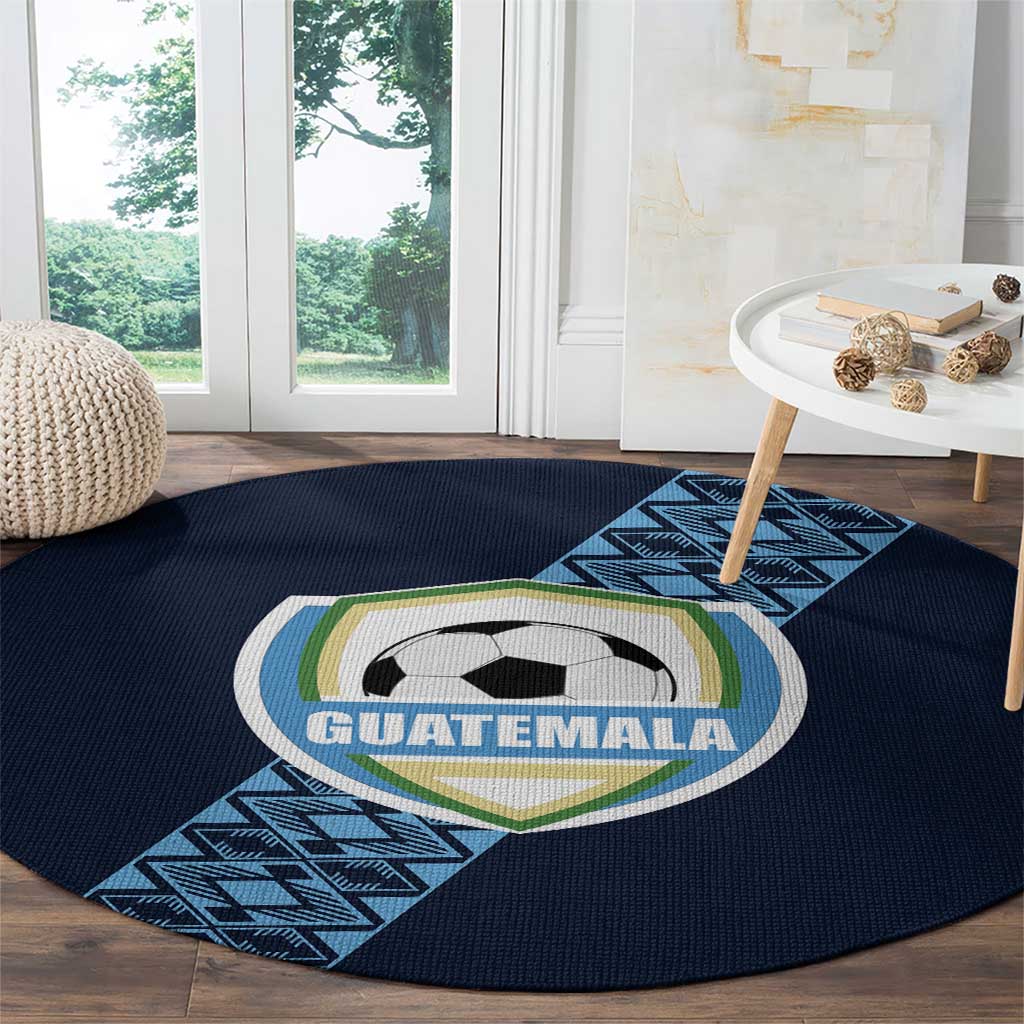 Round dark blue carpet with Guatemala soccer crest, soccer ball, and diagonal blue geometric band