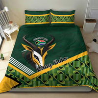 Green baby bedding set with rugby emblem, yellow piping, and checkered pattern on front