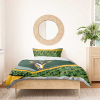 Green baby bedding set on single bed with rugby emblem graphic and yellow accent stripes