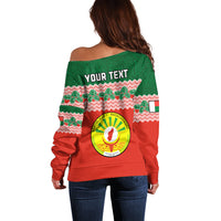 Red and green off-shoulder sweatshirt with zigzag pattern, circular emblem, and 'YOUR TEXT'