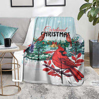 Cardinal Christmas blanket on floor, red cardinals over an evergreen and mint-striped design.