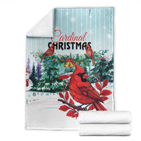 Cardinal Christmas blanket folded with rolled layers, mint blue red cardinals and greenery.