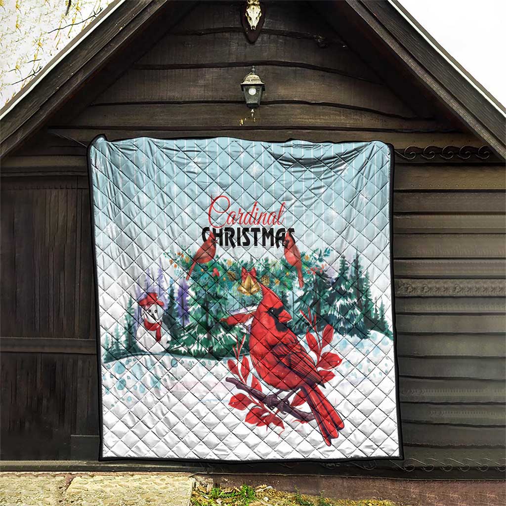 Light blue Cardinal Christmas quilt blanket hung on wall, red cardinal, snow and evergreens