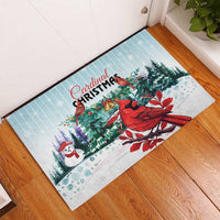 Mint rubber Christmas doormat with red cardinals and pine branches, placed by door