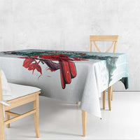 Mint Christmas tablecloth with red cardinals and holly berries near table edge