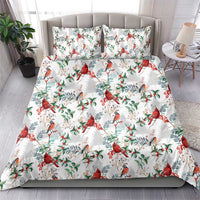White quilted bedding set with red cardinals, blue-gray birds, and green leaf pattern