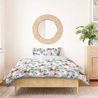 White duvet cover and pillow with red cardinals and green foliage all-over pattern