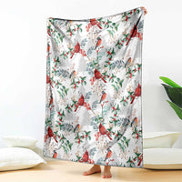Christmas blanket with cardinal bird and holly leaf pattern, draped over bed