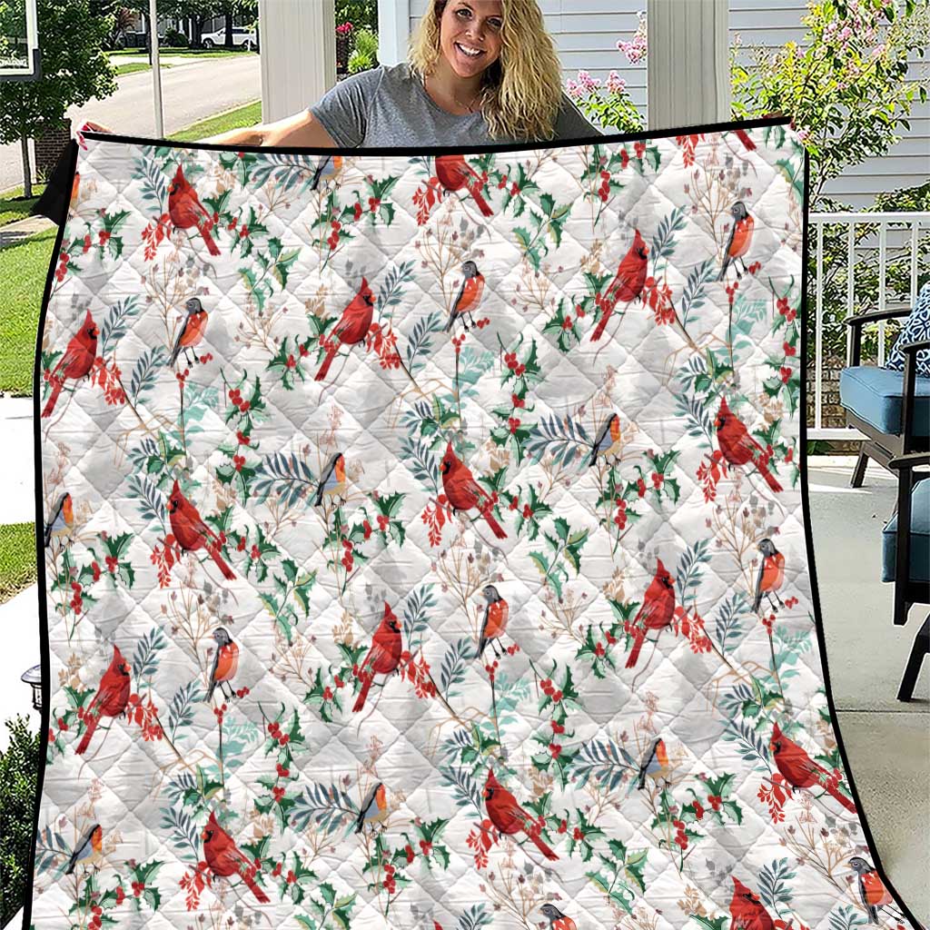 White quilt with red cardinal and green leaf pattern, diamond stitched quilting border
