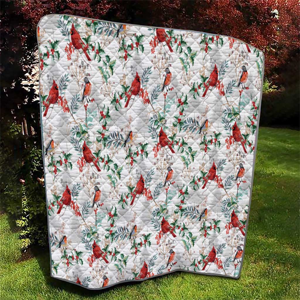 Cardinal Christmas white quilt featuring red birds, green leaves, and quilted diamond pattern