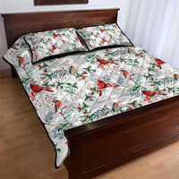 White quilt bed set with cardinal birds and holly leaf pattern; two matching pillows