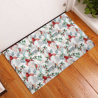 White rubber doormat with red cardinals, green leaves, and holiday berries