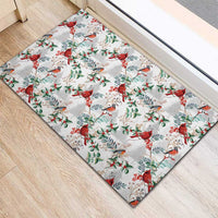 White rubber doormat featuring scattered red cardinals with green foliage and berries