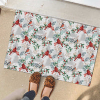 White rubber doormat with red cardinals and green leaves, shown on a doorstep