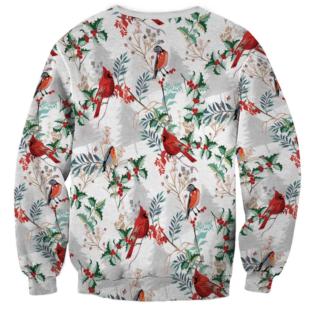 Unisex crewneck sweatshirt in white with cardinal, holly, and leaf pattern, long sleeves