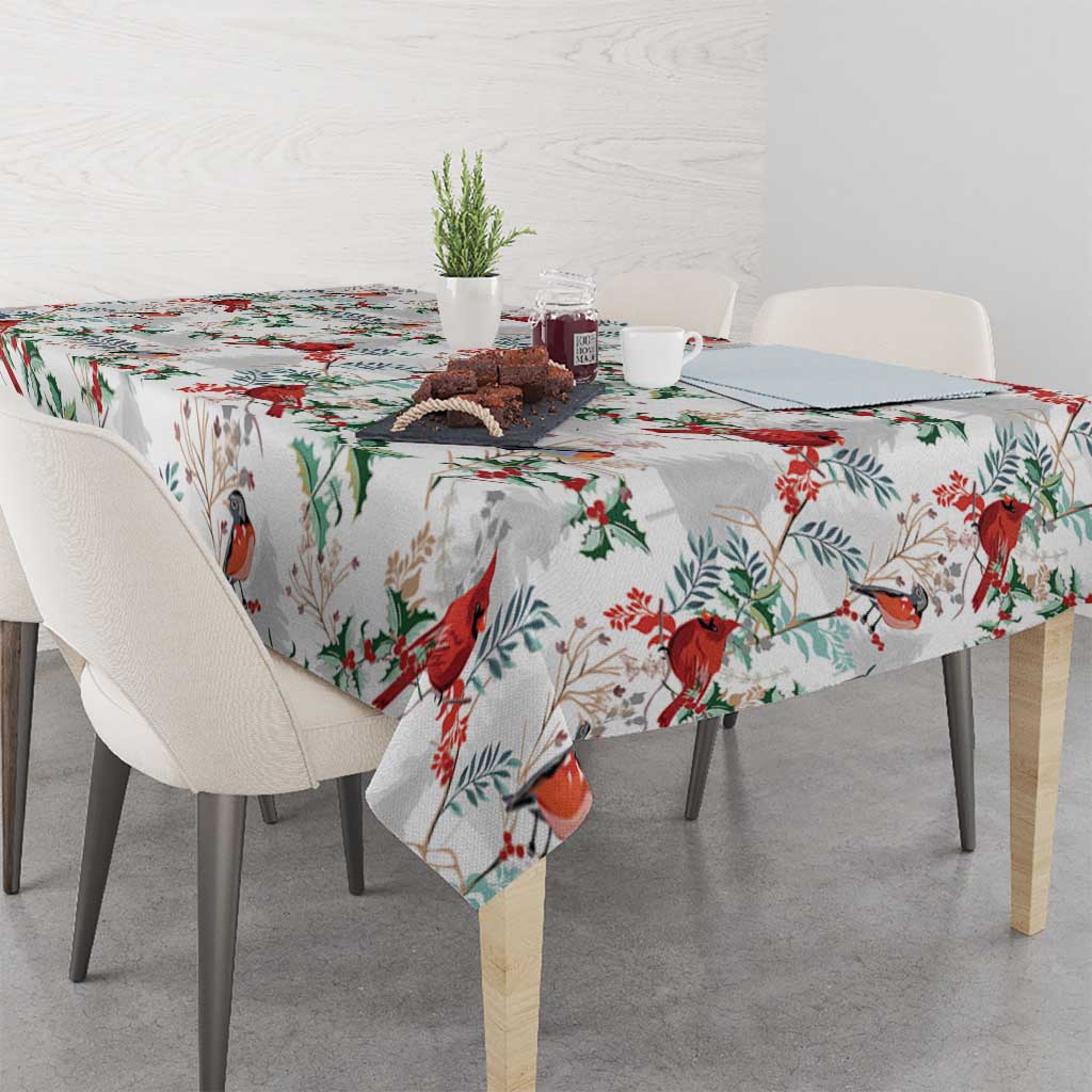 White tablecloth with red cardinal and green foliage print, tabletop and sides covered