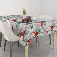 White tablecloth with red cardinal and green foliage print, tabletop and sides covered