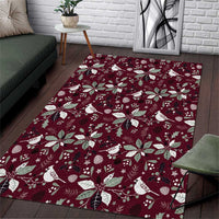 Wine red area rug with white poinsettias and birdhouse/bird pattern