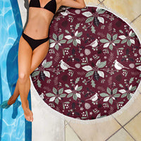 Round wine-red beach blanket with white birds and holly pattern, fringe trim