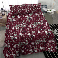 Deep red holiday bedding set with white bird, wreath and poinsettia pattern on duvet and shams