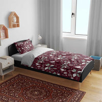 Deep red duvet cover and pillow shams featuring white bird and poinsettia holiday pattern